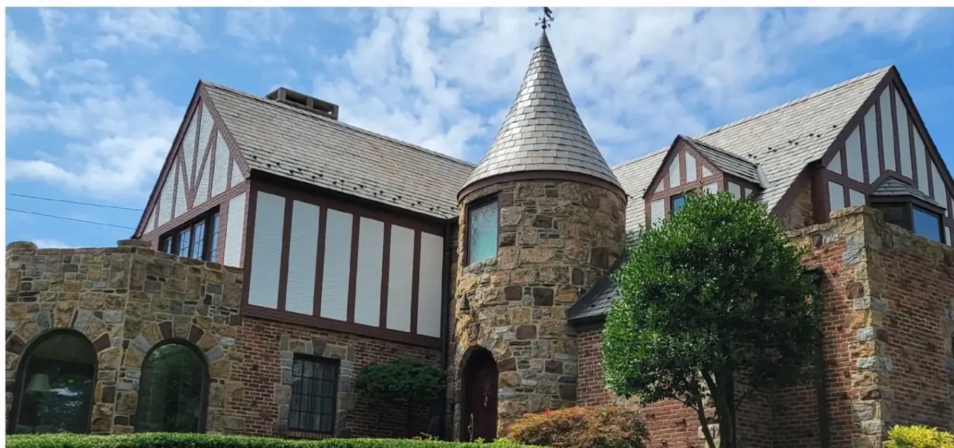 Stone Tudor with a slate turret in Manhasset after slate cleaning